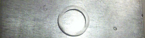 Ring filed on a shiny metal block.
